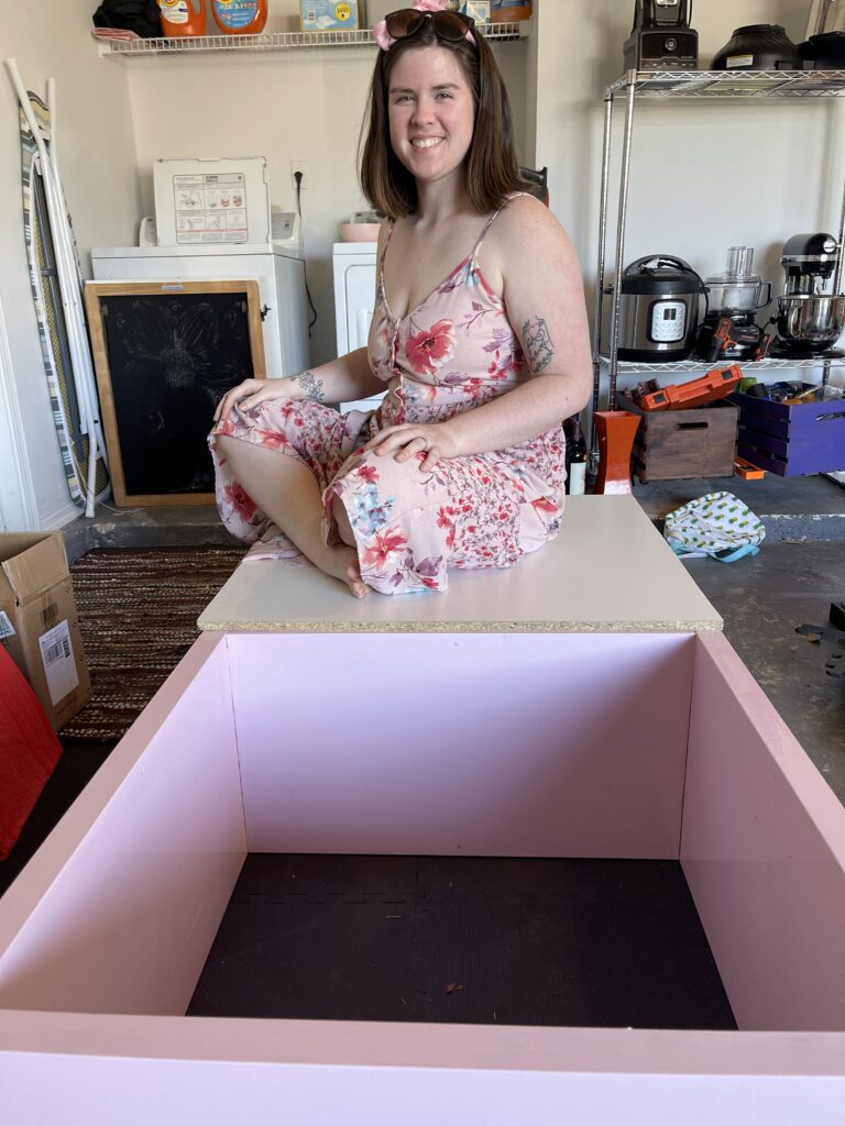 mallory sitting on cat birthing box